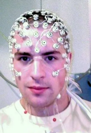 Person wearing EEG cap with 64 electrodes